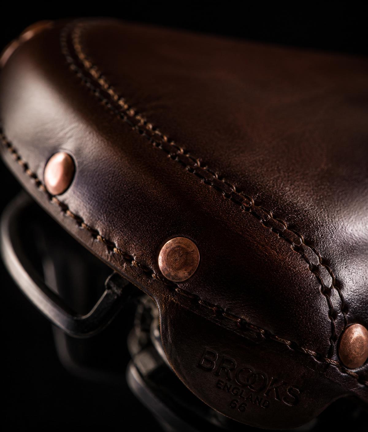 Hand-stitched brown leather saddle with copper rivets